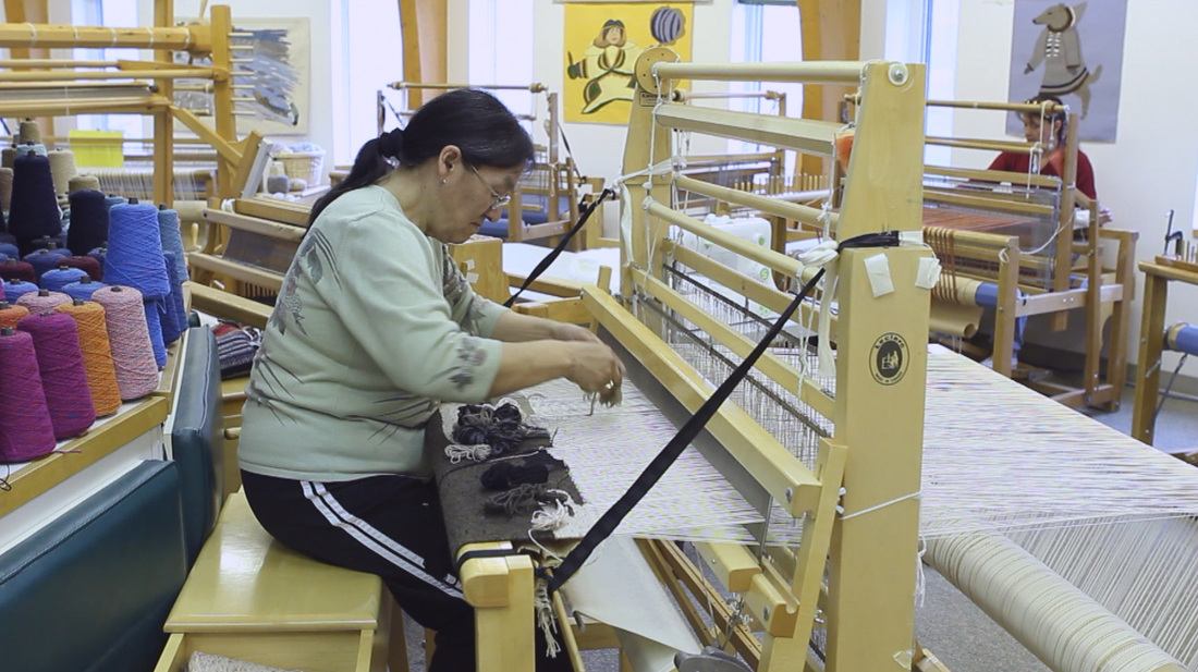 Kawtysie Kakee is weaving in the Uqqurmiut Centre for Arts and Crafts in Pangnirtung on Baffin Island. ©2013 Sivummut